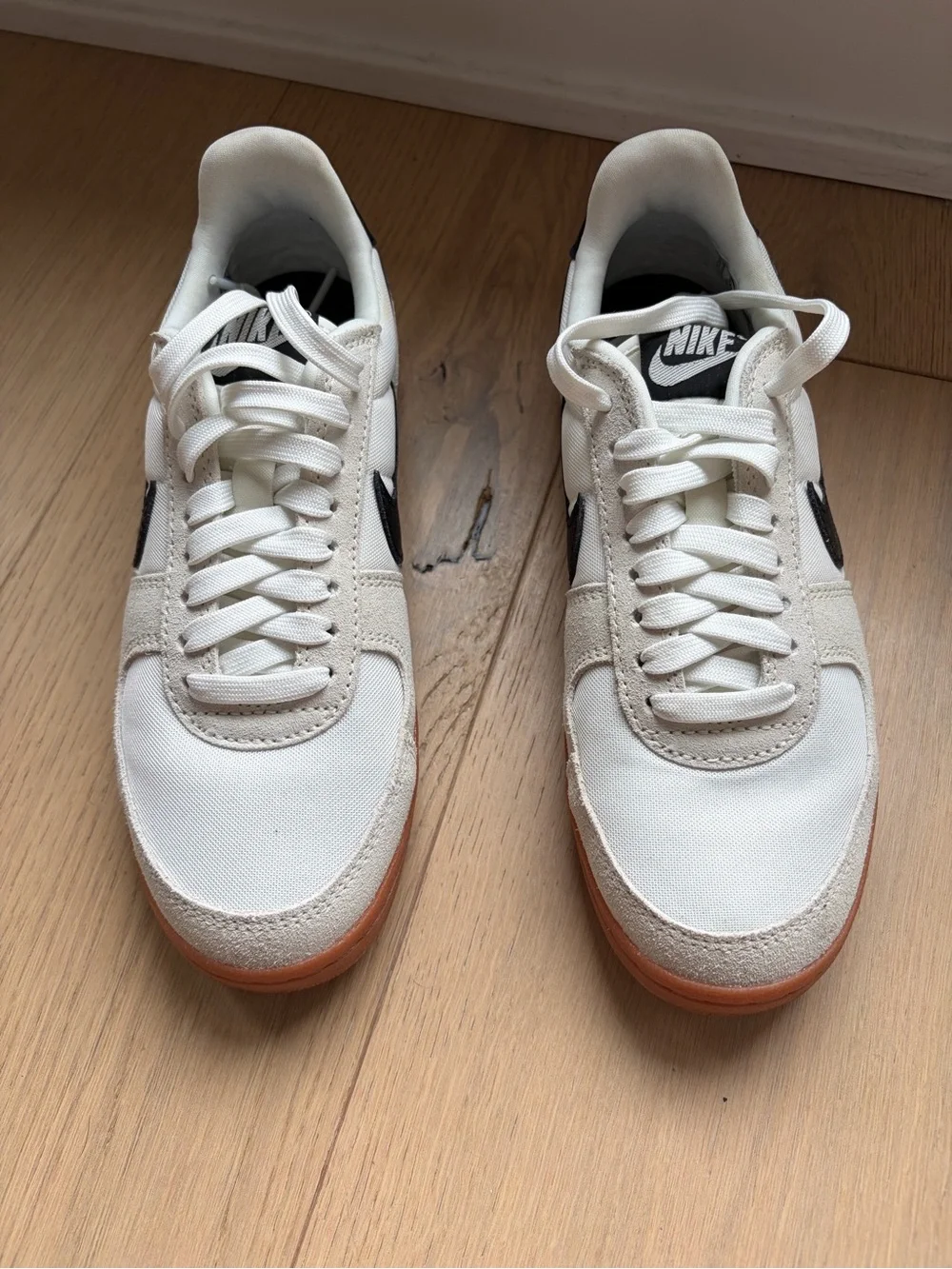 Nike Women’s White Sneakers with Brown Outsole and Black Swoosh